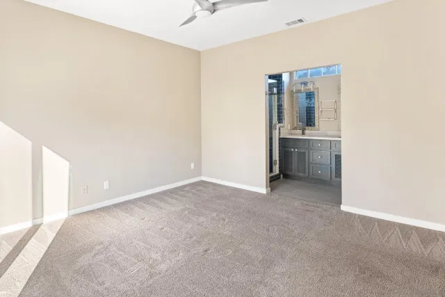 a bathroom with a shower sink and mirror