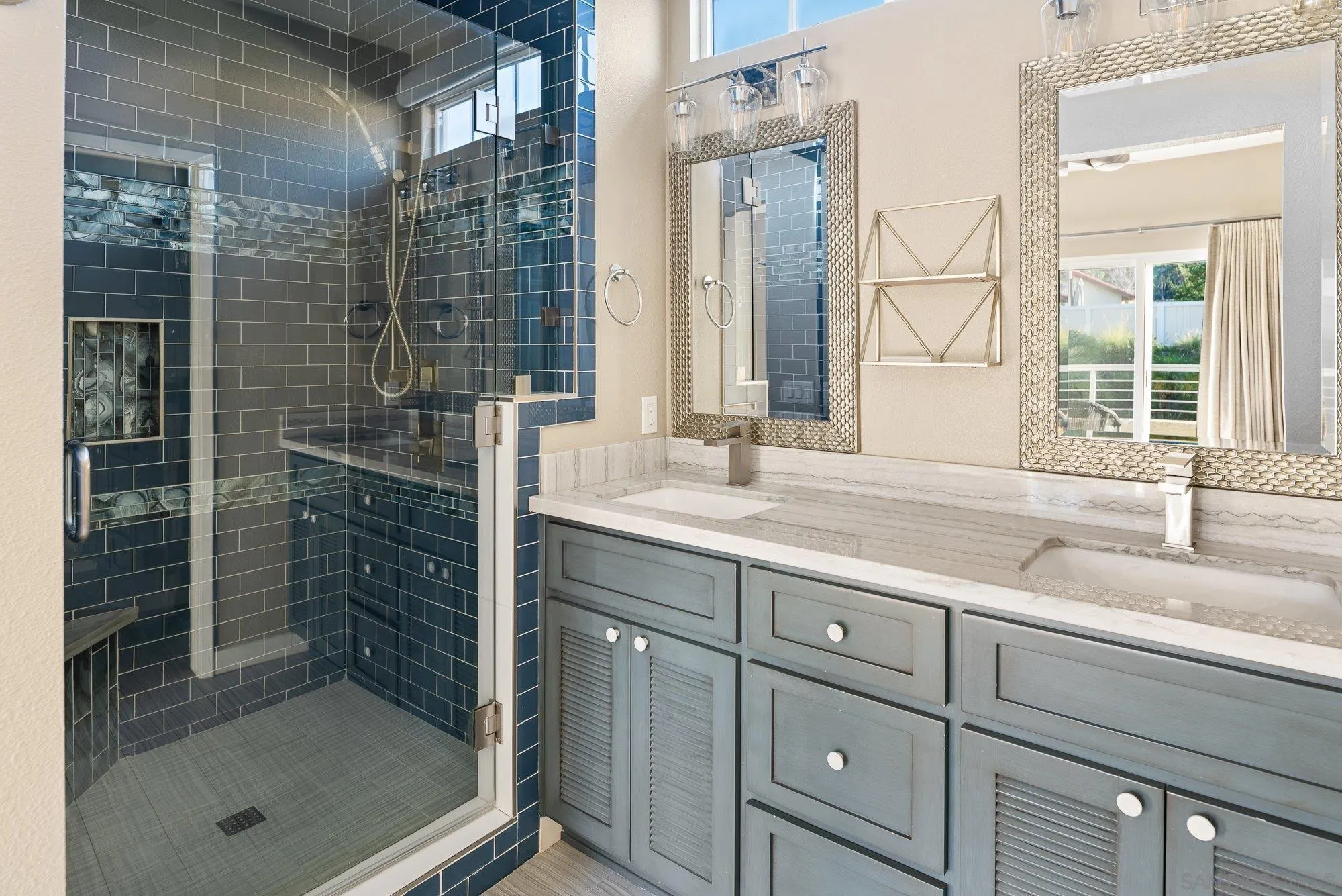 14274 Woodcreek Road Poway, CA 92064 - Photo 24 of 57 a bathroom with a shower sink and mirror
