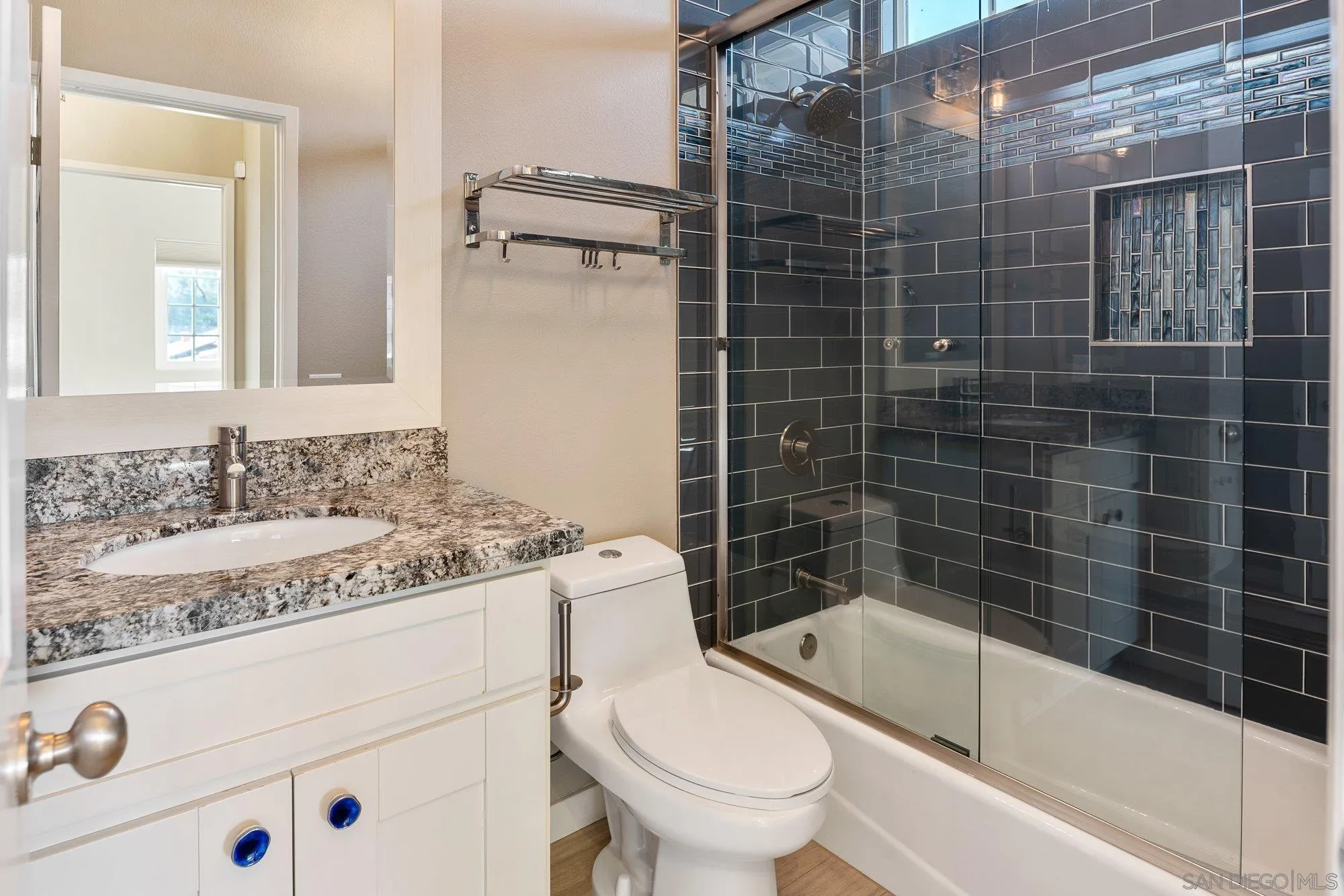 14274 Woodcreek Road Poway, CA 92064 - Photo 30 of 57 a bathroom with a granite countertop toilet a sink and bathtub