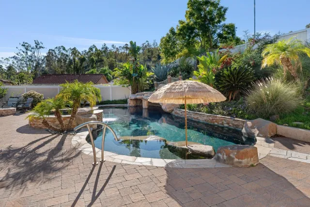 a view of a swimming pool with chairs