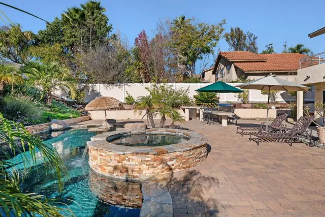 an aerial view of a house yard swimming pool and outdoor seating