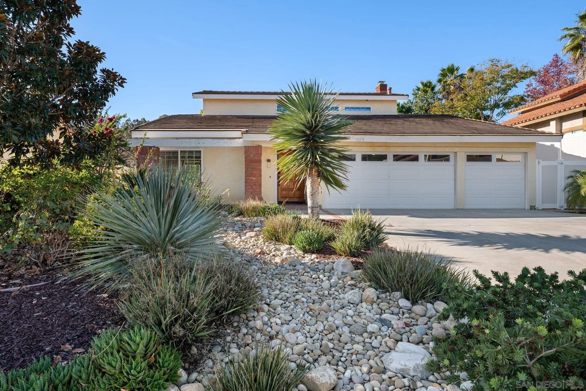 14274 Woodcreek Road Poway, CA 92064 - Photo 5 of 57 a front view of a house with a yard