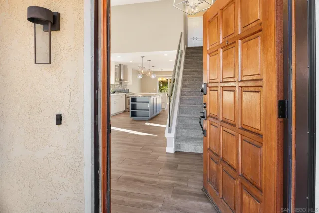 a view of kitchen with granite countertop cabinets and refrigerator