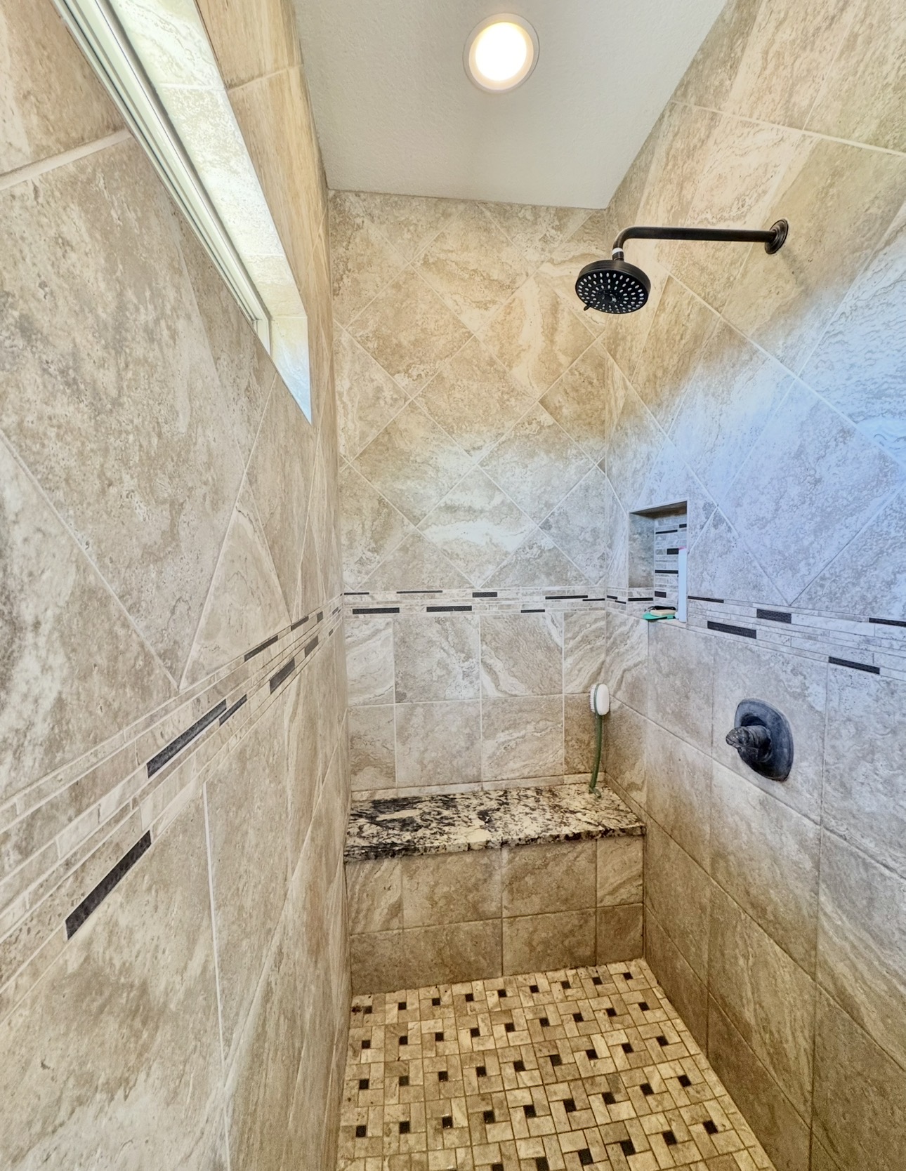 1094 Raintree Lane Elgin, TX 78621 - Photo 27 of 39 Tiled walk-in shower with rain head shower head and seat.
