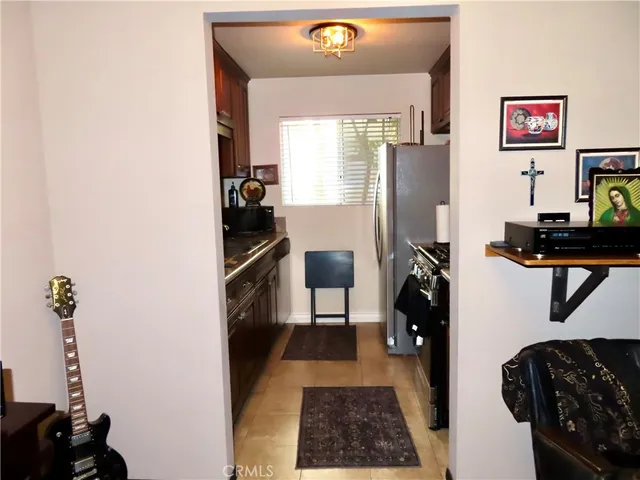 a view of a hallway with workspace and a window