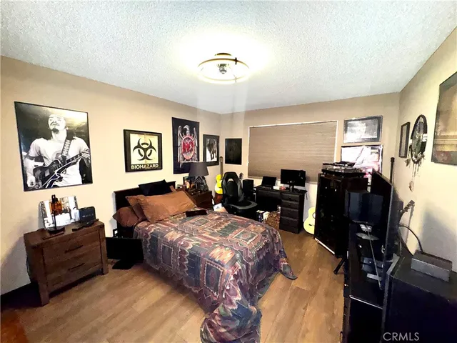 a bed room with furniture and wooden floor