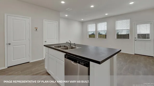 a kitchen that has a sink and a stove