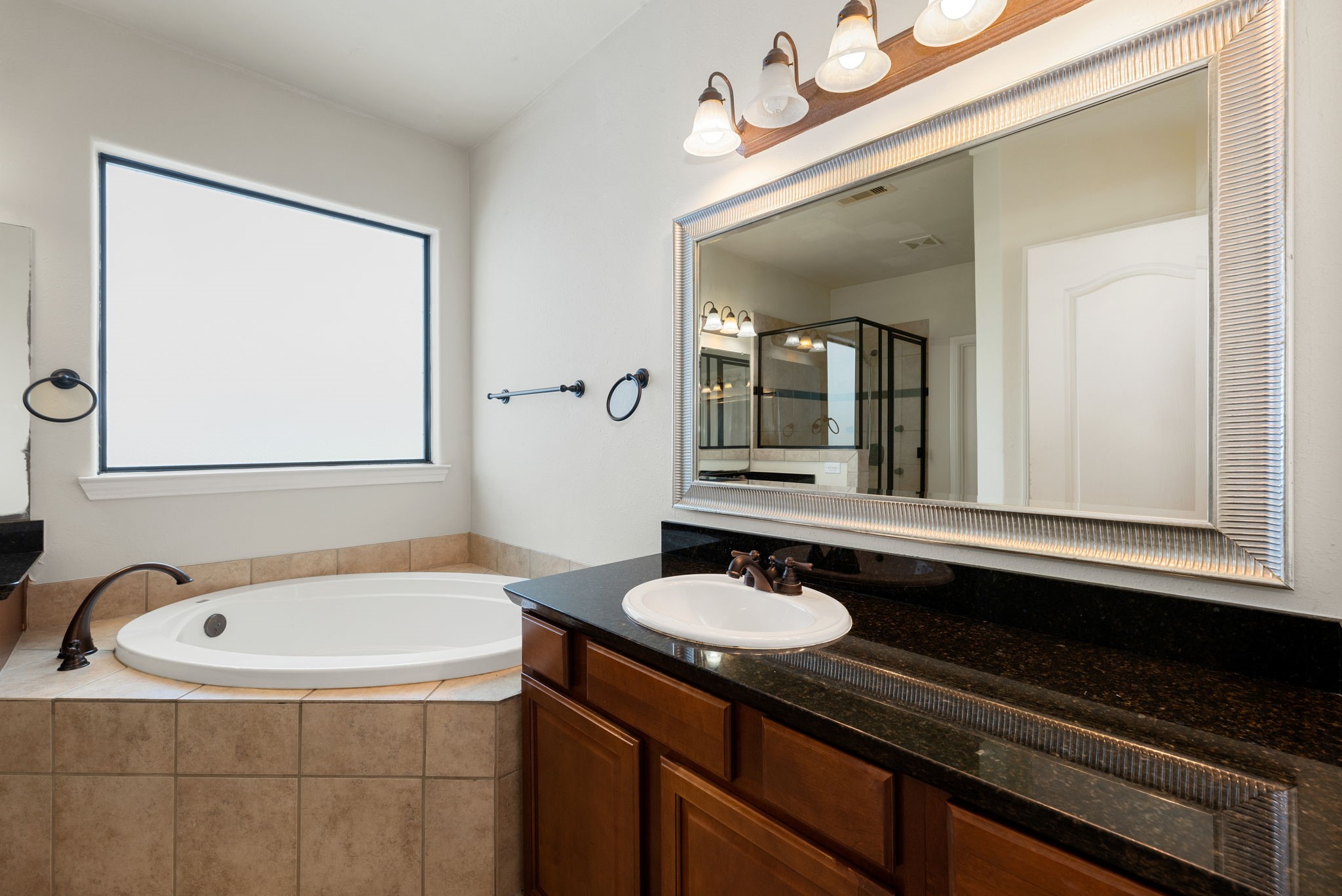 1353 Studer Street Houston, TX 77007 - Photo 18 of 35 a bathroom with a sink and a mirror