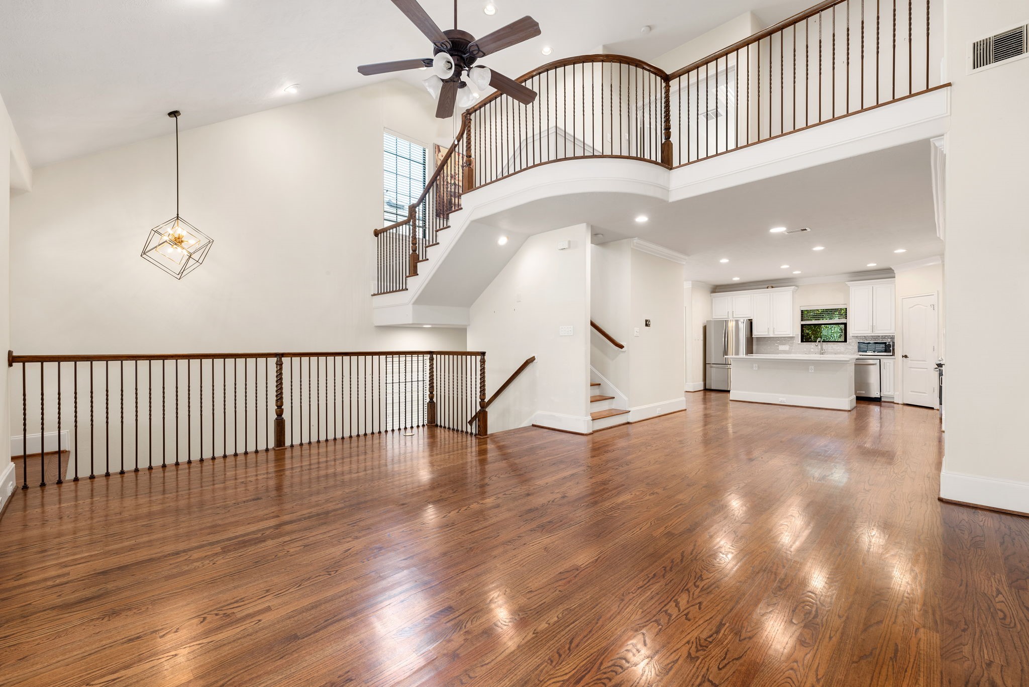 1353 Studer Street Houston, TX 77007 - Photo 2 of 35 a view of a hallway with wooden floor and staircase