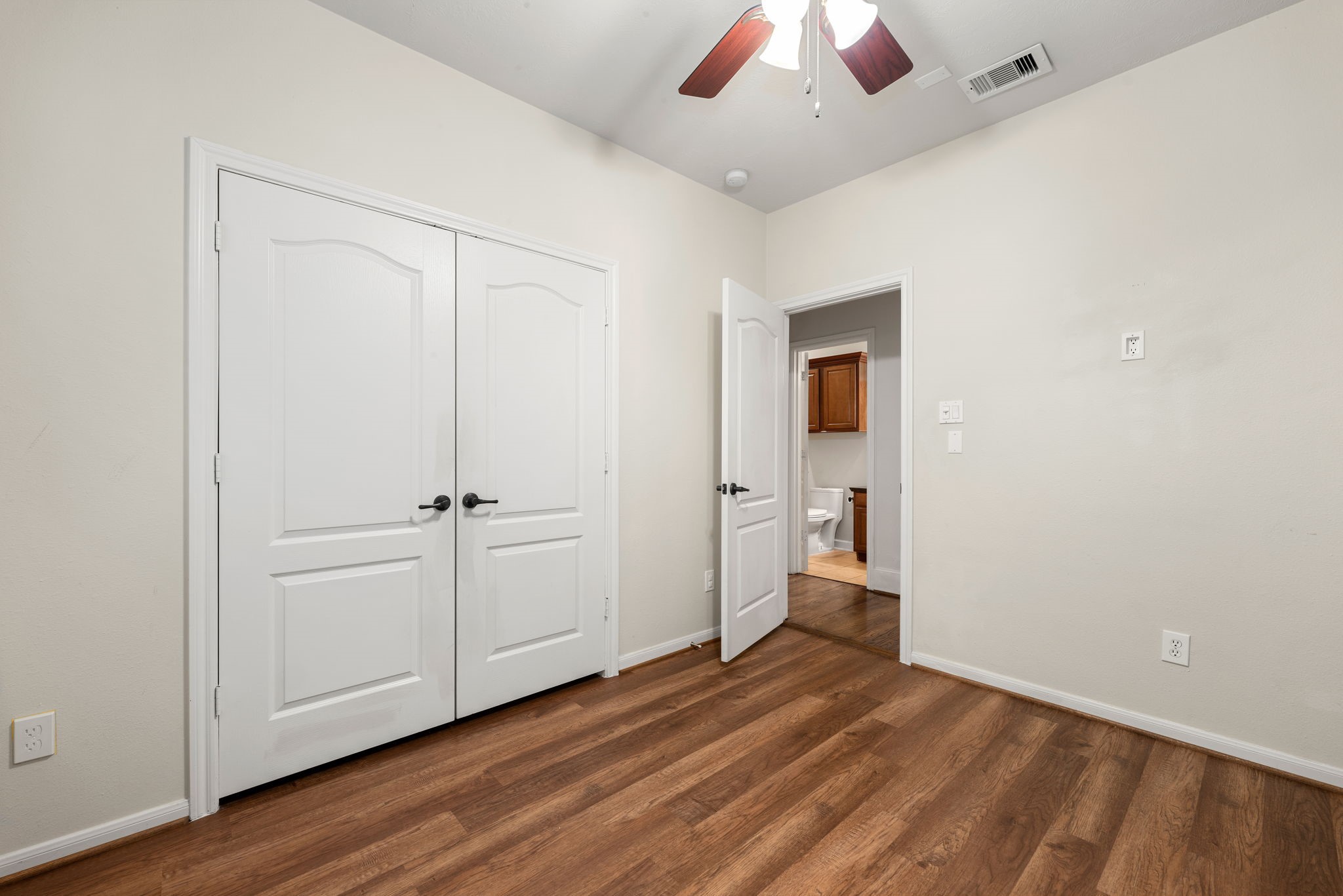 1353 Studer Street Houston, TX 77007 - Photo 22 of 35 an empty room with wooden floor closet and windows