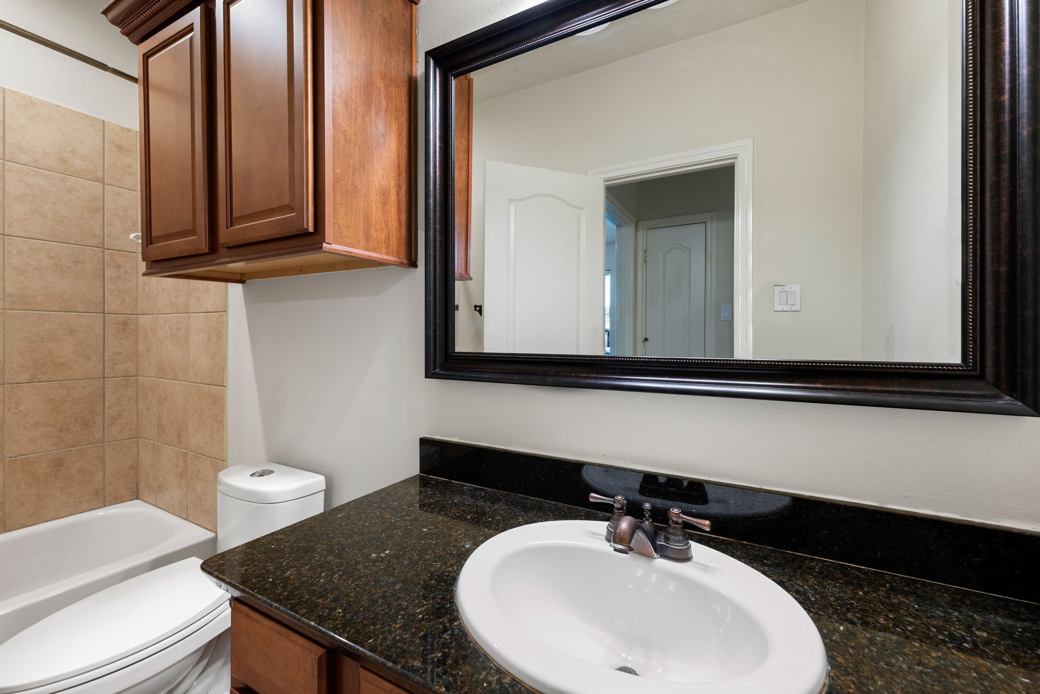 1353 Studer Street Houston, TX 77007 - Photo 25 of 35 a bathroom with a sink a toilet and mirror