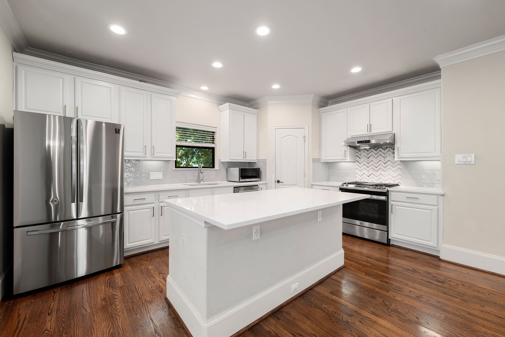 1353 Studer Street Houston, TX 77007 - Photo 3 of 35 a kitchen with stainless steel appliances granite countertop a refrigerator and a stove top oven