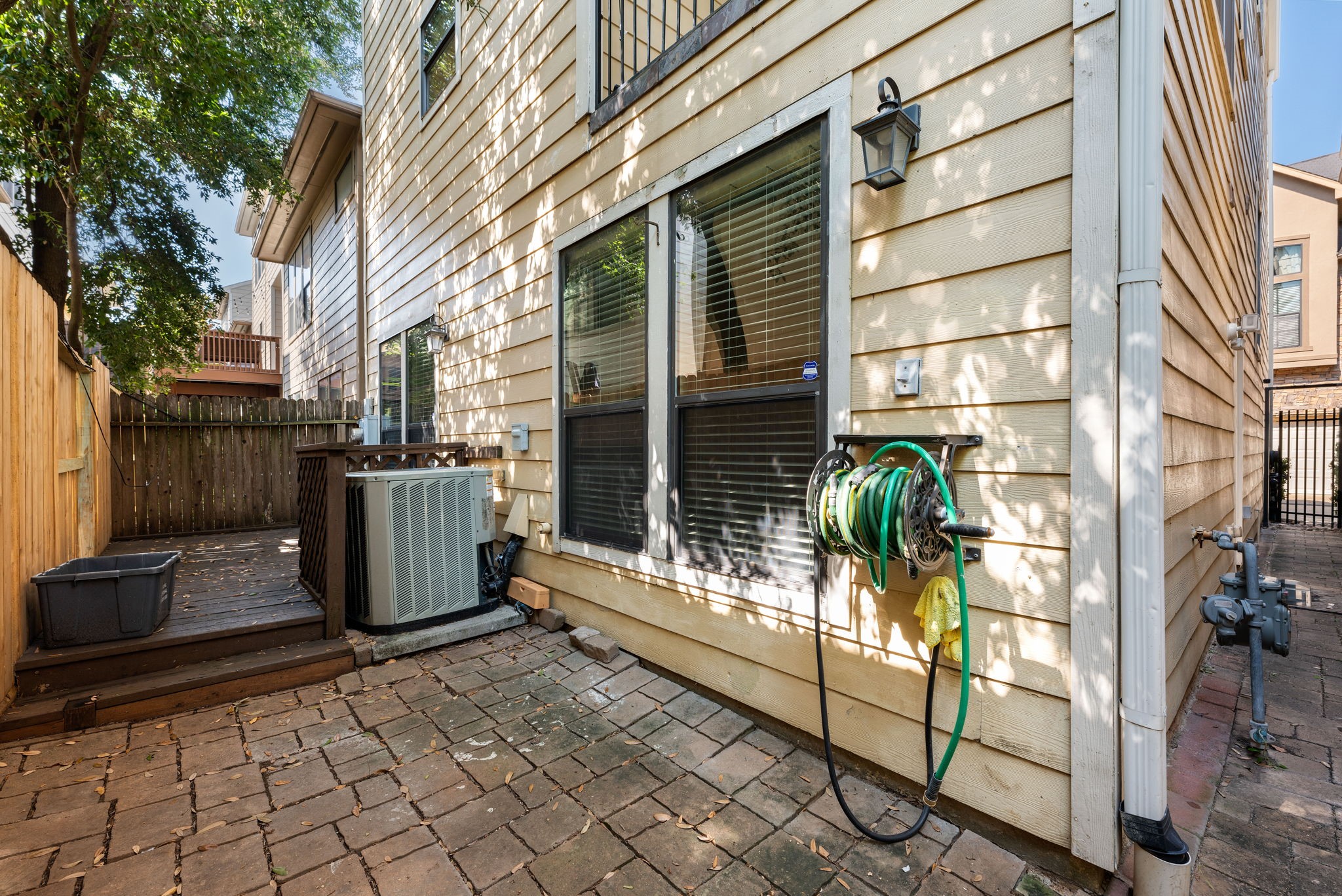 1353 Studer Street Houston, TX 77007 - Photo 32 of 35 a view of a house with a large window and wooden fence