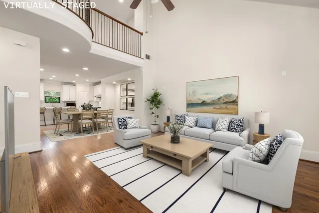 a living room with furniture and a view of kitchen