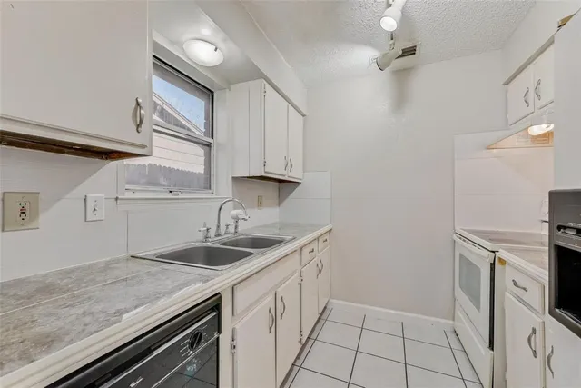 a kitchen with a sink and cabinets