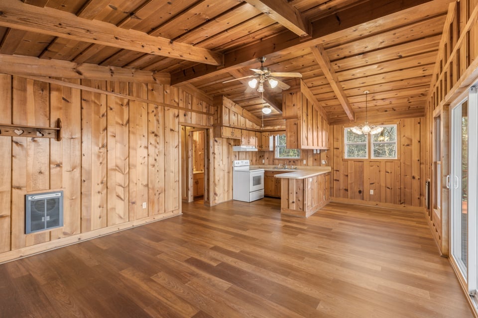 795 Buck Falls Road Highlands, NC 28741 - Photo 6 of 39 Open concept living room featuring solid wood paneling and natural light