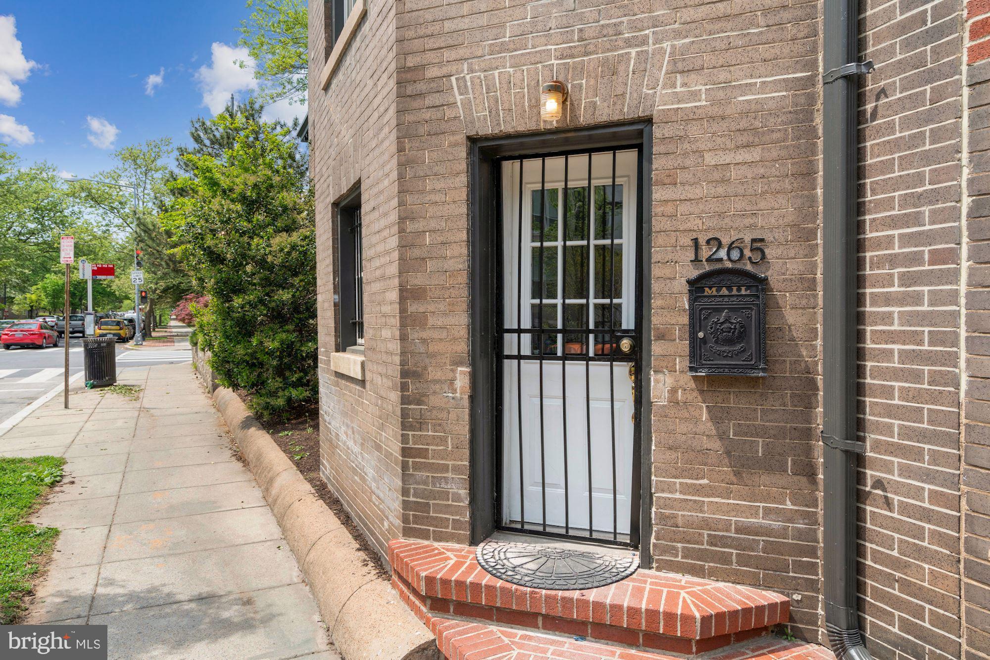 3001 13th Street Northwest, Unit B Washington, DC 20009 - Photo 3 of 11 a view of house with a potted plant ana a small yard