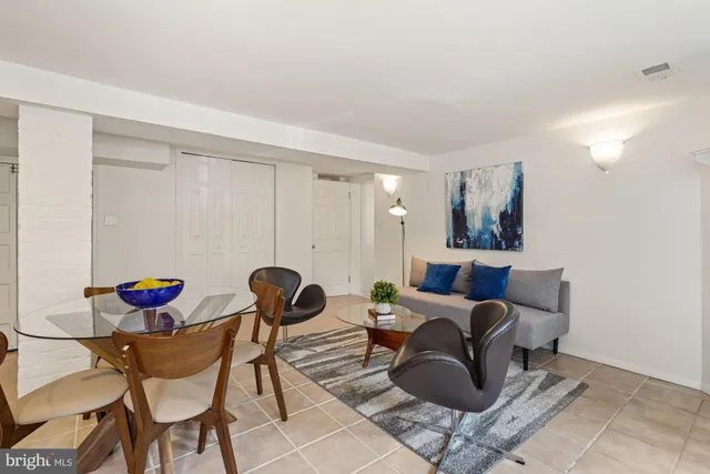 a living room with furniture and a mirror