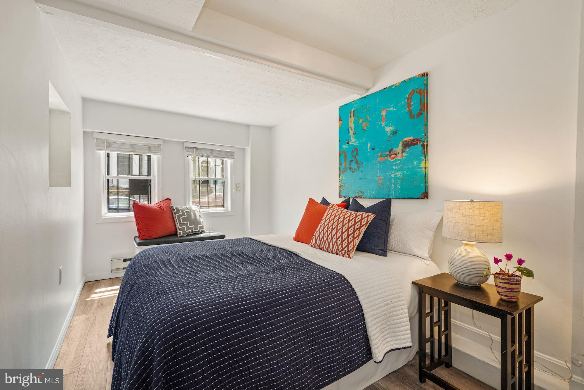 3001 13th Street Northwest, Unit B Washington, DC 20009 - Photo 8 of 11 a bedroom with a bed and wooden floor