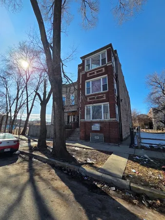 a view of a building with cars parked