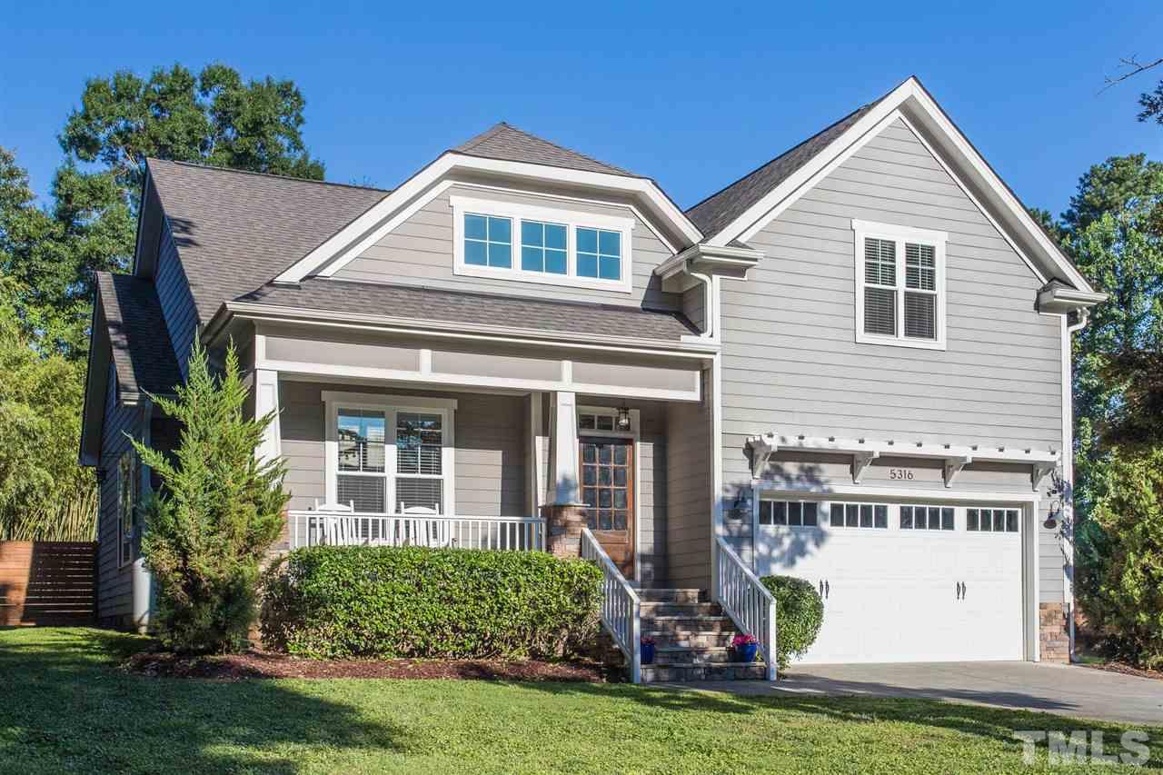5316 Olive Road Raleigh, NC 27606 - Photo 1 of 29 a front view of a house with a yard and potted plants