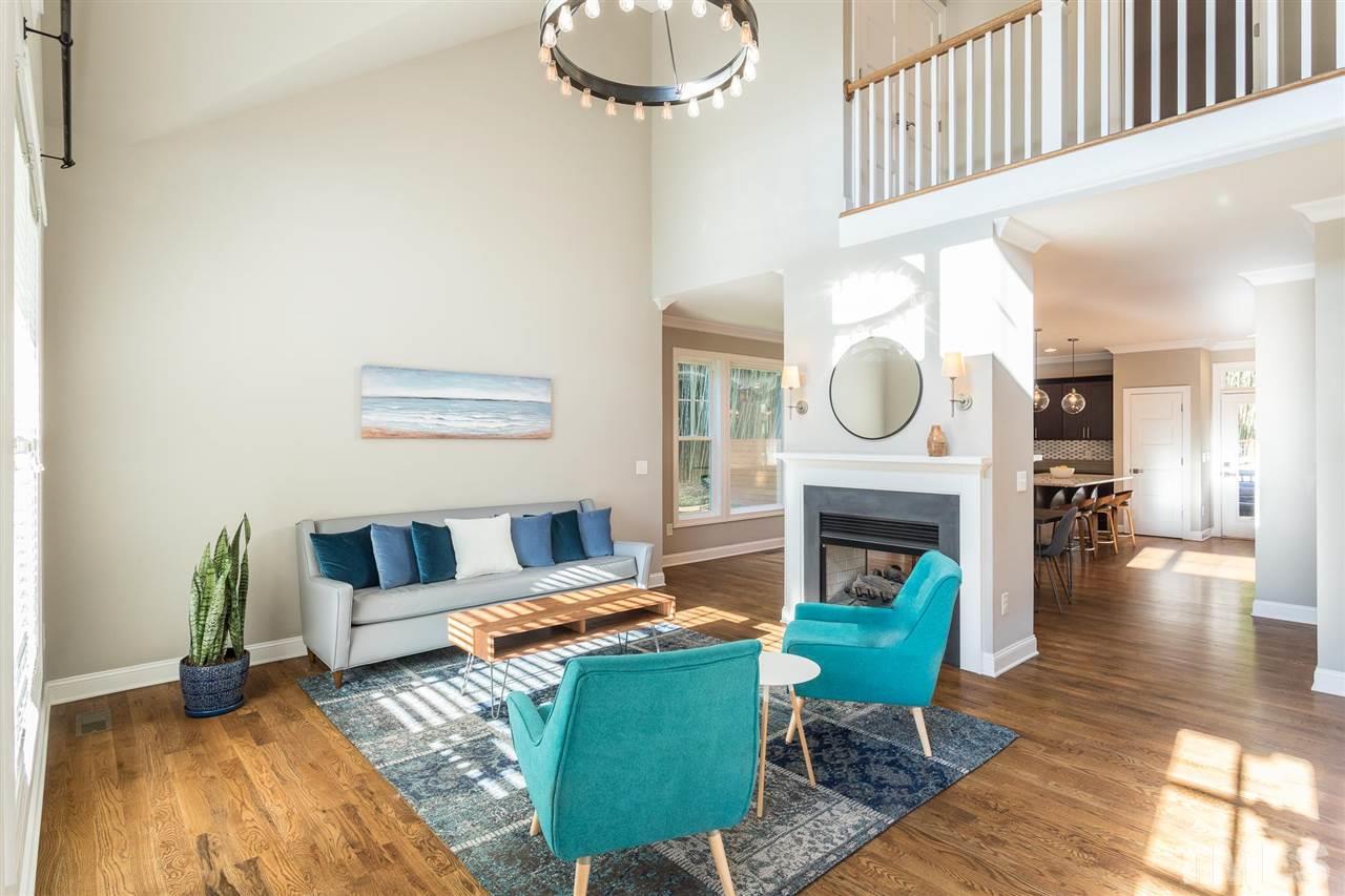 5316 Olive Road Raleigh, NC 27606 - Photo 11 of 29 a living room with furniture a fireplace and a table