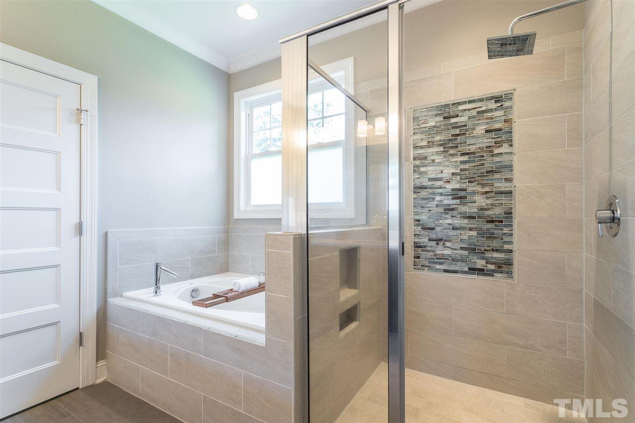 5316 Olive Road Raleigh, NC 27606 - Photo 16 of 29 a bathroom with a bathtub and shower