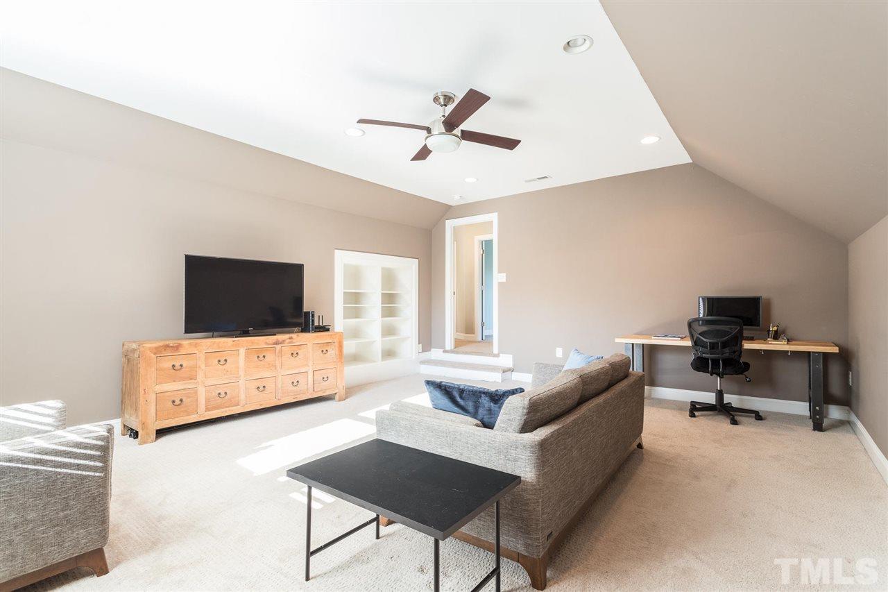 5316 Olive Road Raleigh, NC 27606 - Photo 22 of 29 a living room with furniture and a flat screen tv