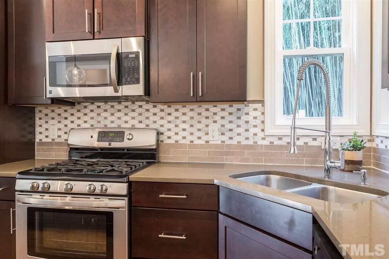 5316 Olive Road Raleigh, NC 27606 - Photo 6 of 29 a kitchen with a stove and a sink