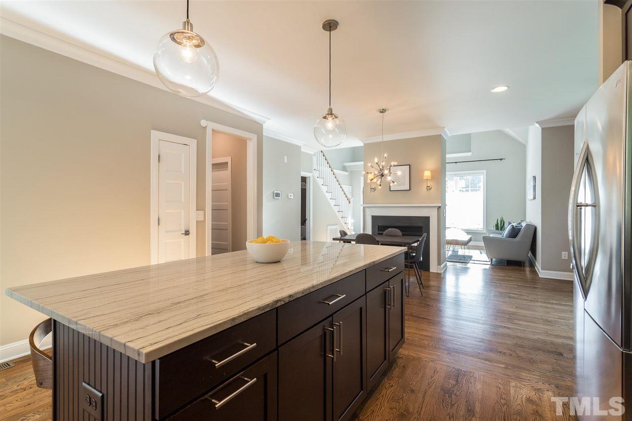 5316 Olive Road Raleigh, NC 27606 - Photo 8 of 29 a kitchen with sink cabinets and wooden floor