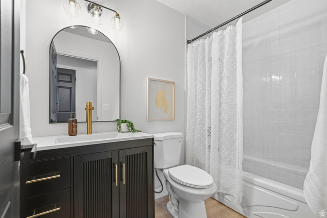 2460 Allison Way Syracuse, UT 84075 - Photo 20 of 24 Contemporary bathroom with a black vanity featuring gold-finish hardware, a rectangular undermount sink, and a gold-finish faucet