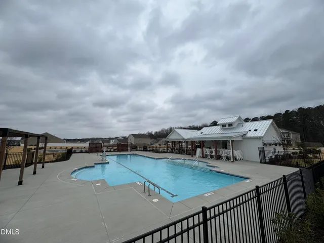 a view of a swimming pool with furniture