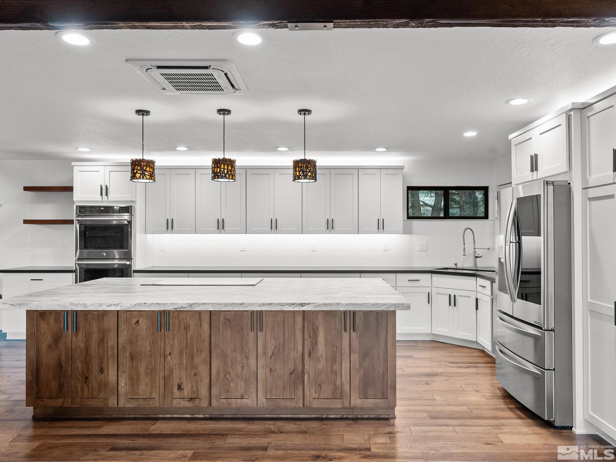 2036 Breen Drive Reno, NV 89509 - Photo 12 of 38 a kitchen with stainless steel appliances kitchen island granite countertop a refrigerator and stove