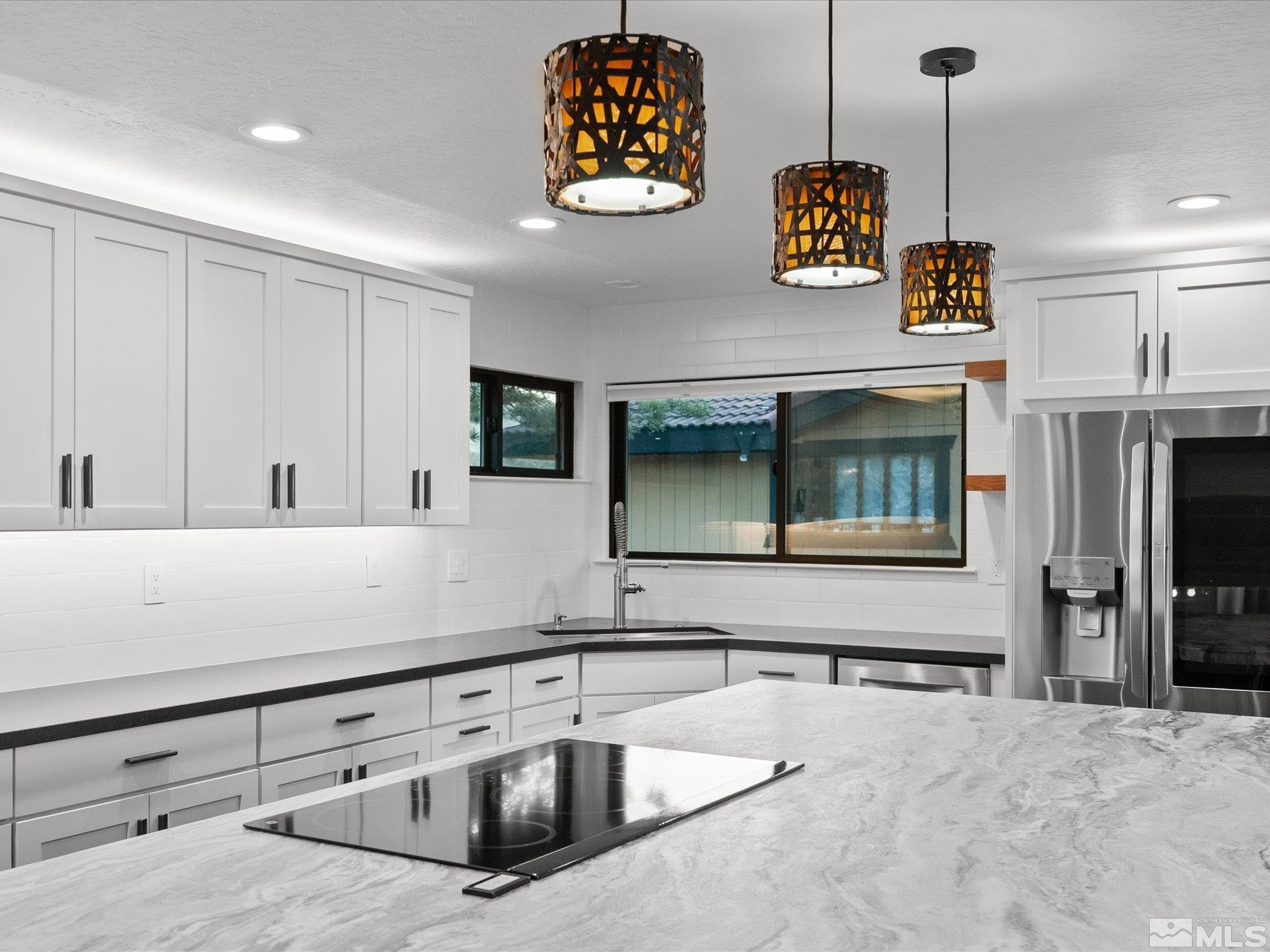 2036 Breen Drive Reno, NV 89509 - Photo 15 of 38 a kitchen with stainless steel appliances granite countertop a sink a stove and a microwave