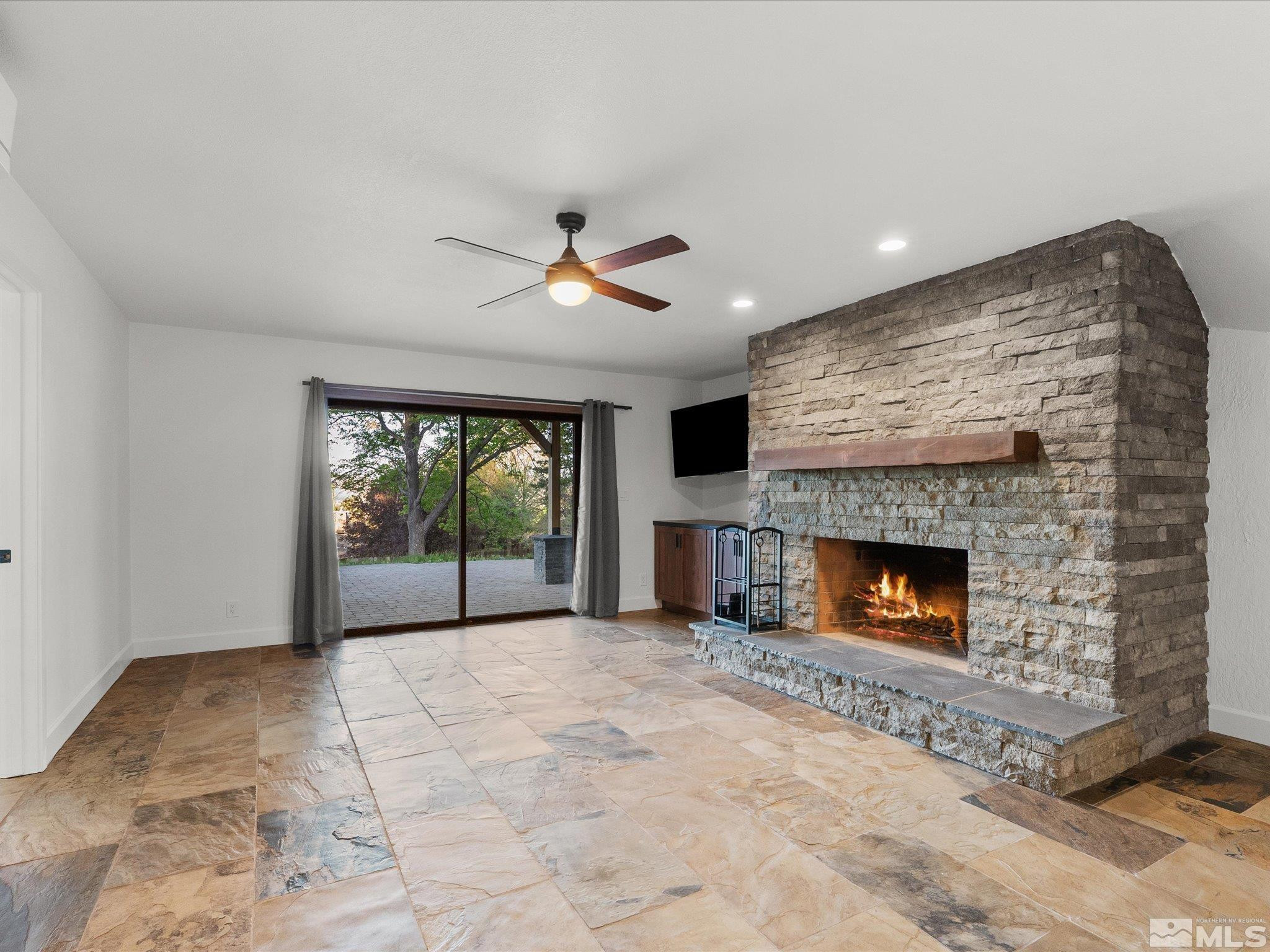 2036 Breen Drive Reno, NV 89509 - Photo 16 of 38 a view of an empty room with a fireplace and a large window