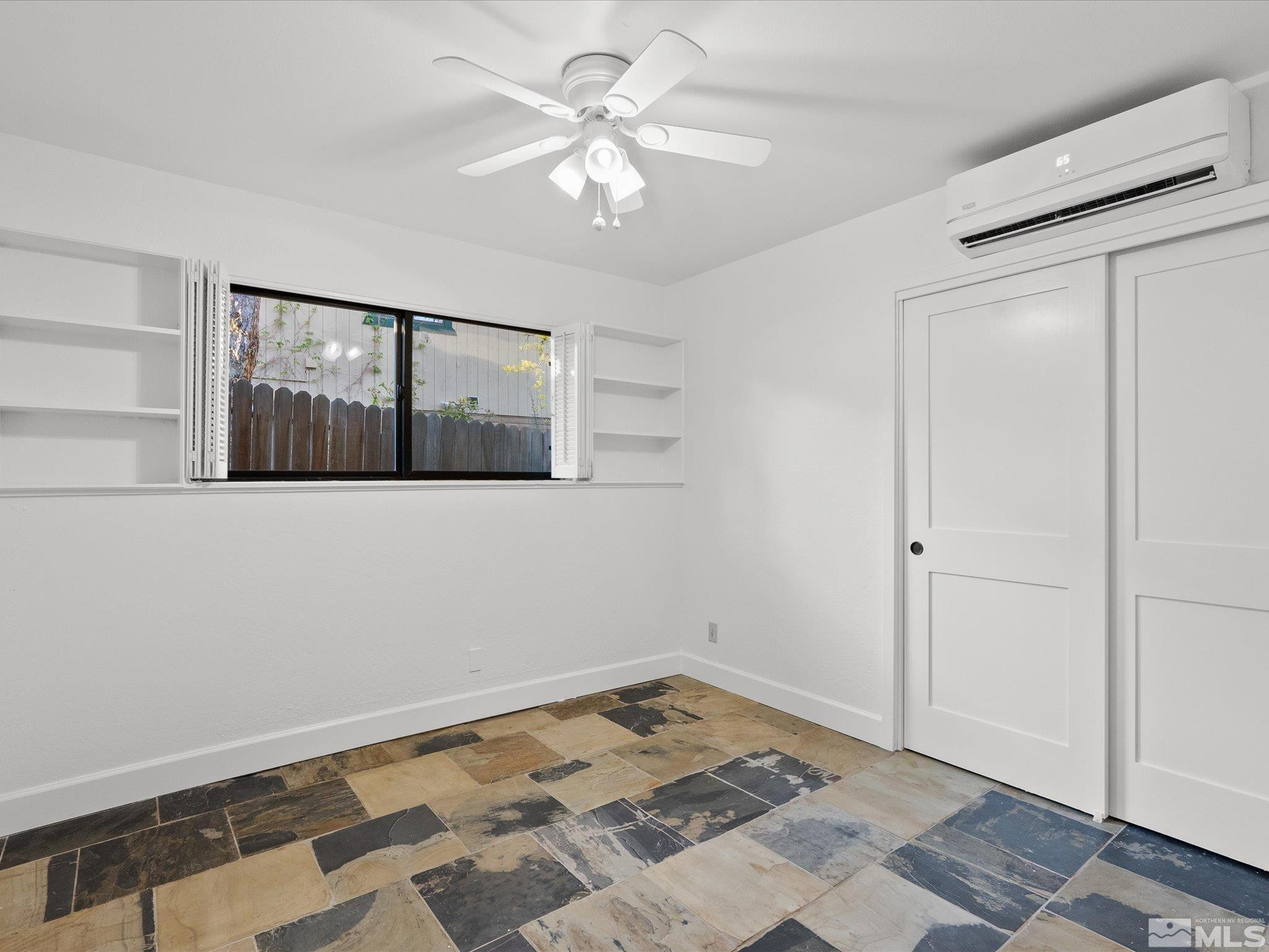 2036 Breen Drive Reno, NV 89509 - Photo 17 of 38 a view of a livingroom with wooden floor and a ceiling fan