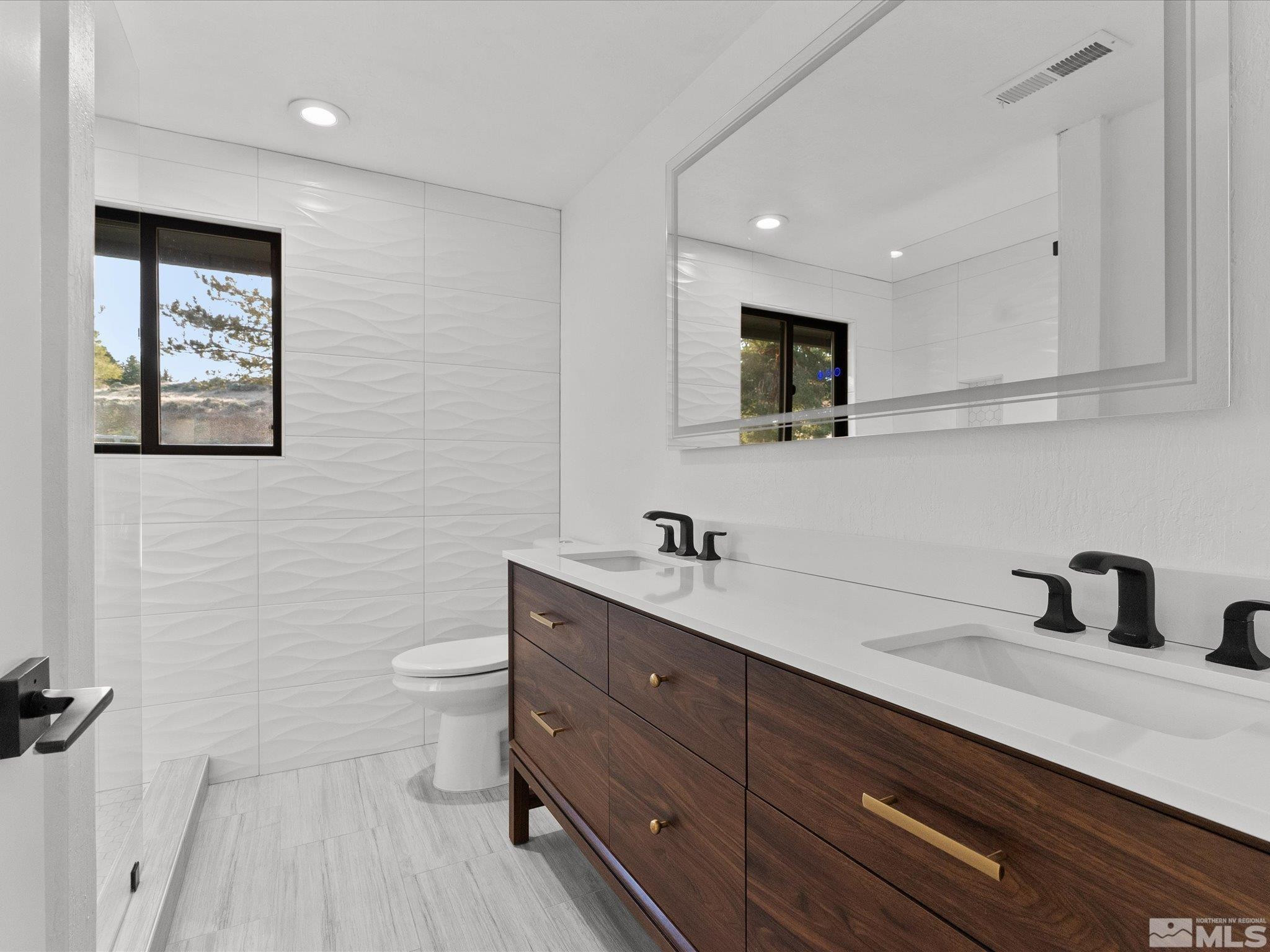 2036 Breen Drive Reno, NV 89509 - Photo 26 of 38 a bathroom with a toilet sink double vanity and mirror