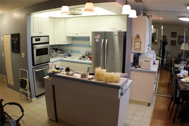 a kitchen with refrigerator and cabinets