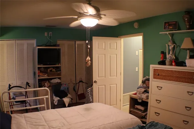 a bedroom with furniture and a flat tv screen