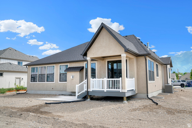 11718 South Halls Crk Road Draper, UT 84020 - Photo 6 of 28 Stucco exterior featuring a covered deck with white railings, a concrete patio, and a dark shingled roof