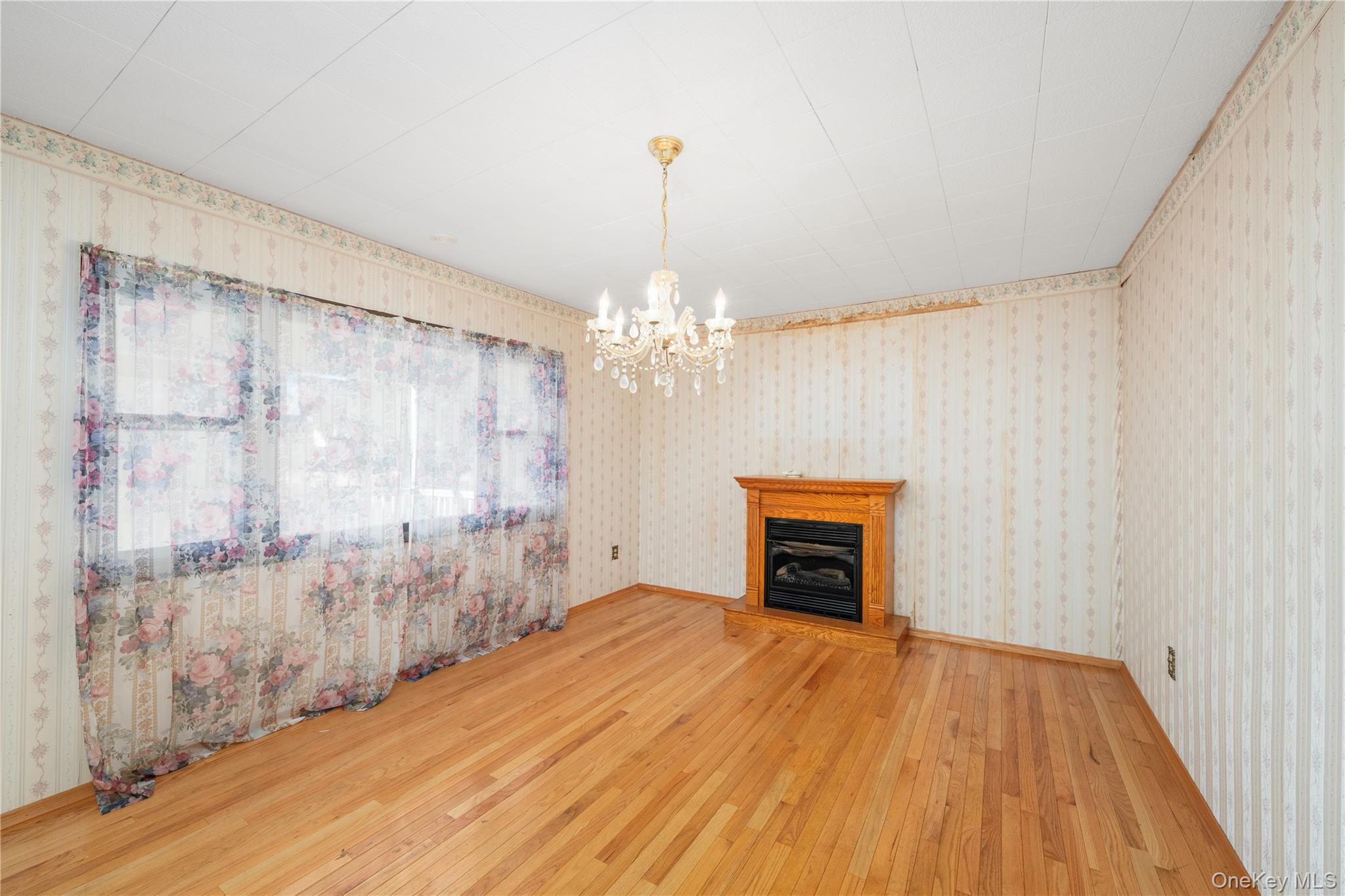 7 Duncan Street Beacon, NY 12508 - Photo 8 of 22 a view of a livingroom with a chandelier wooden floor and windows