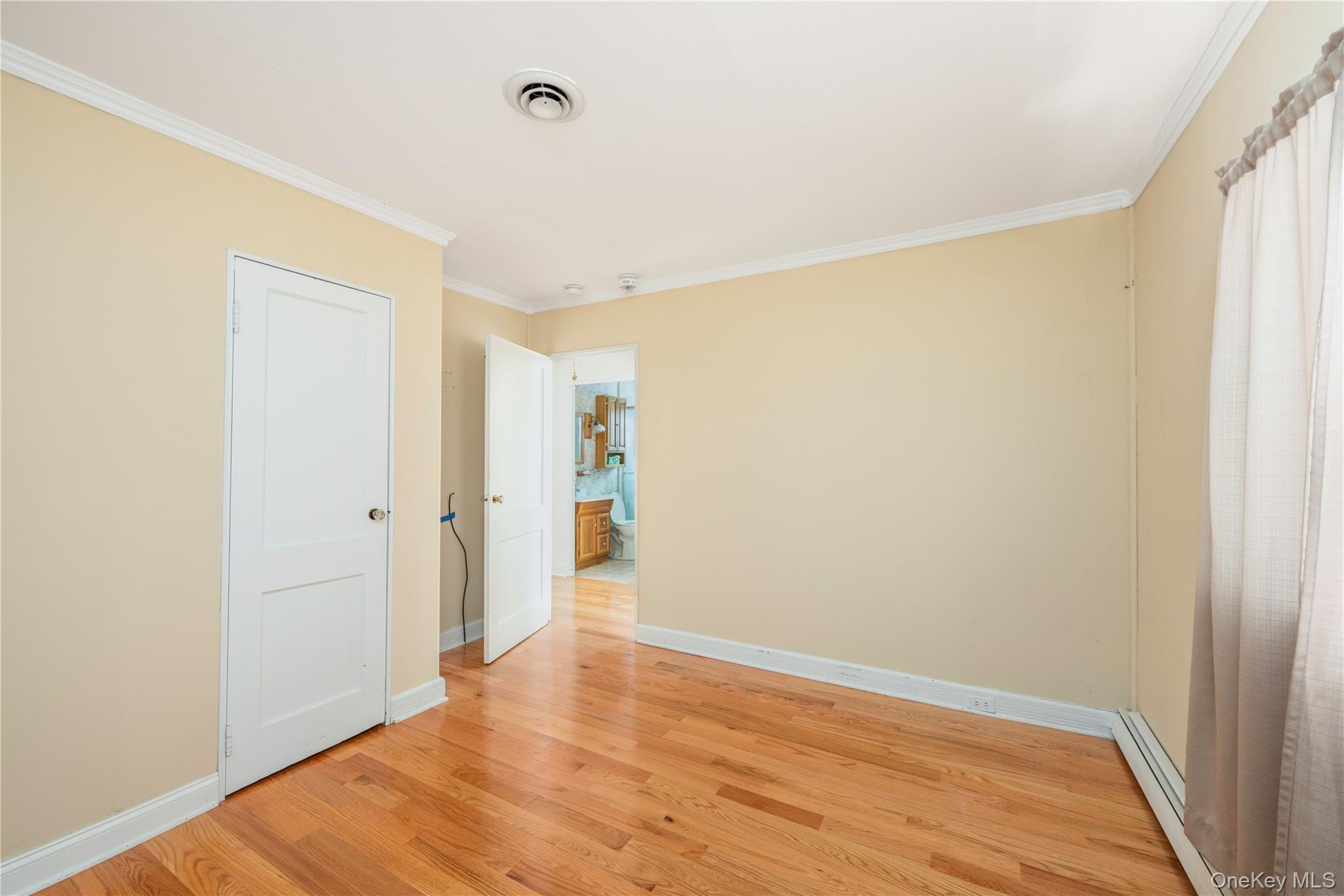 7 Duncan Street Beacon, NY 12508 - Photo 10 of 22 a view of an empty room with wooden floor and a window