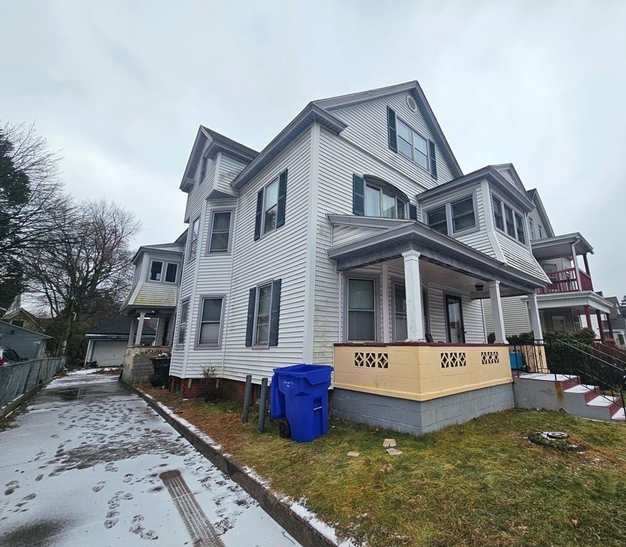 a front view of a house with yard and sitting area