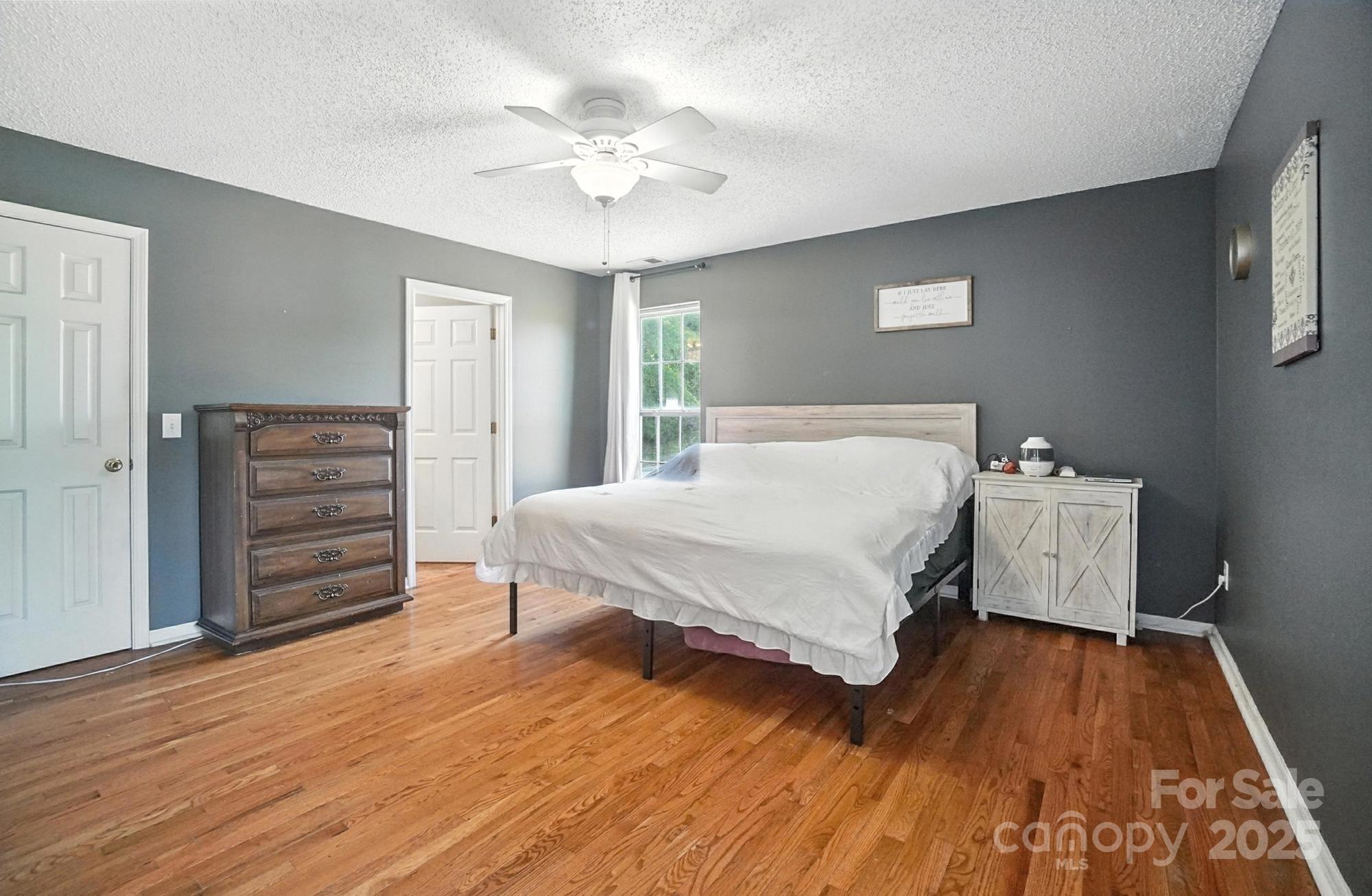 1116 State Rd S-29-770 Kershaw, SC 29067 - Photo 20 of 48 a bedroom with a bed and a chandelier