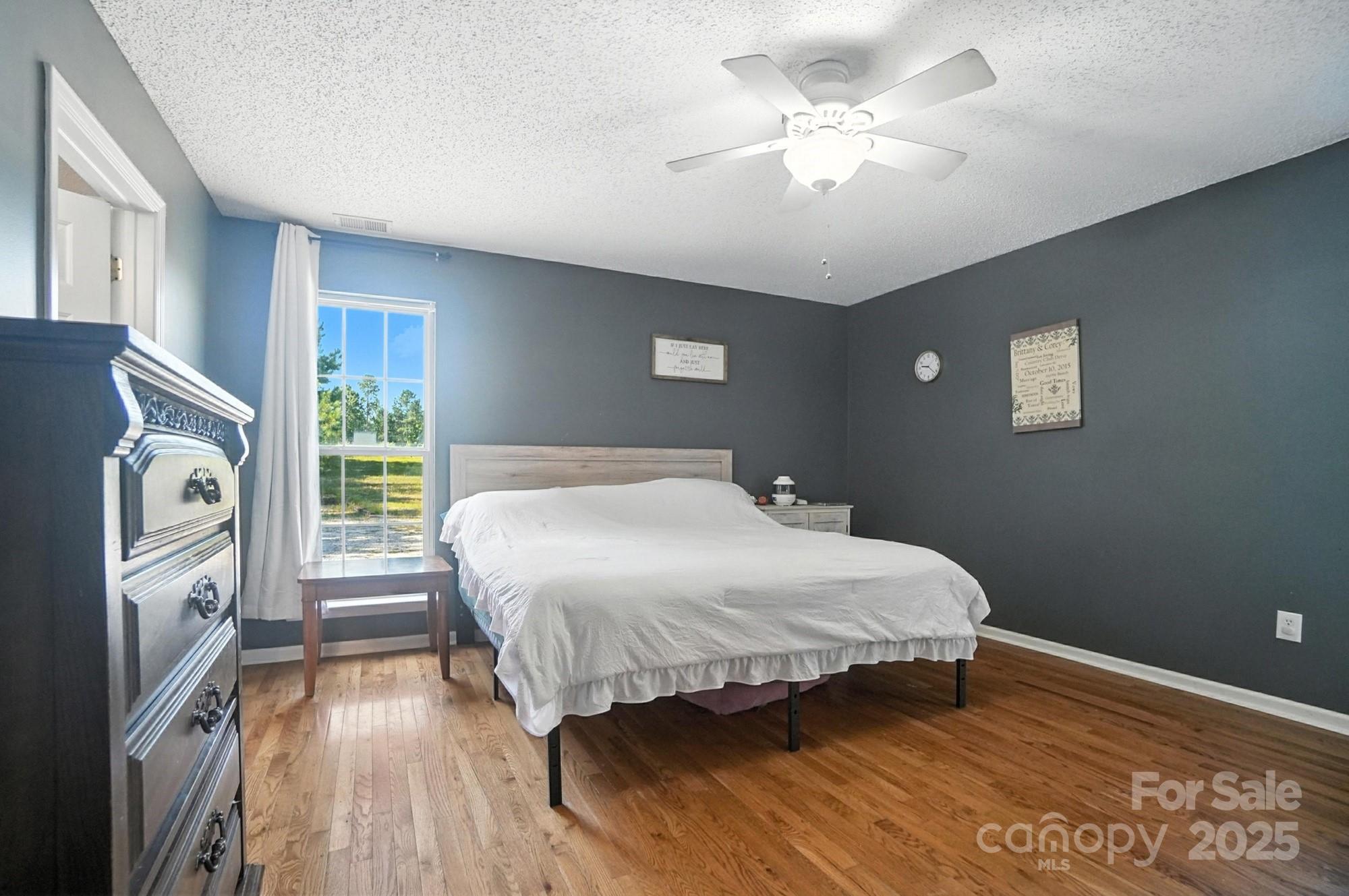 1116 State Rd S-29-770 Kershaw, SC 29067 - Photo 21 of 48 a bedroom with a large bed and a chandelier
