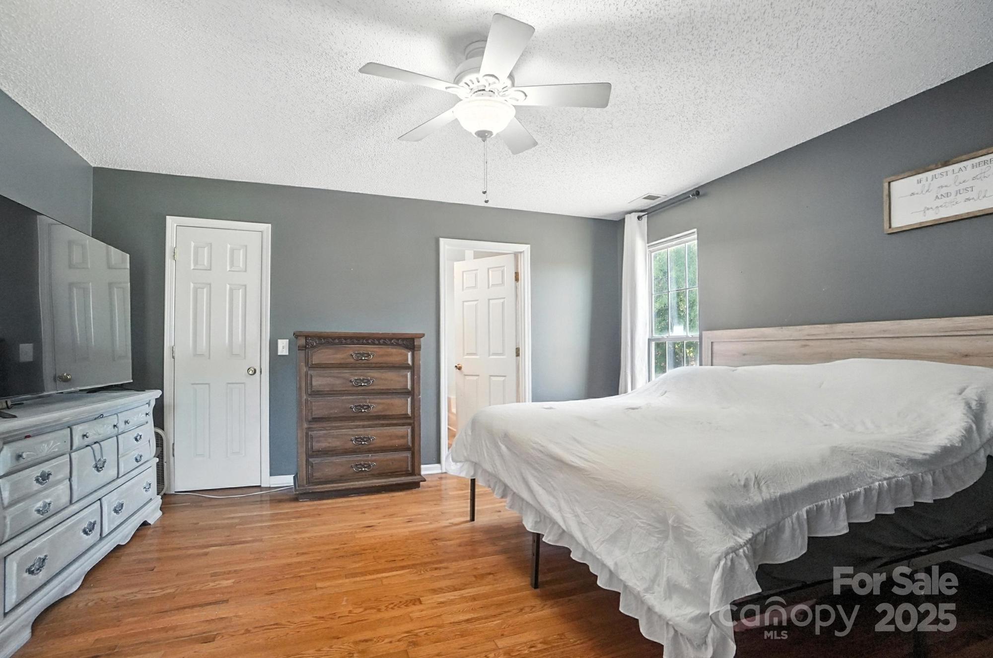 1116 State Rd S-29-770 Kershaw, SC 29067 - Photo 22 of 48 a bedroom with a bed a dresser and a chandelier