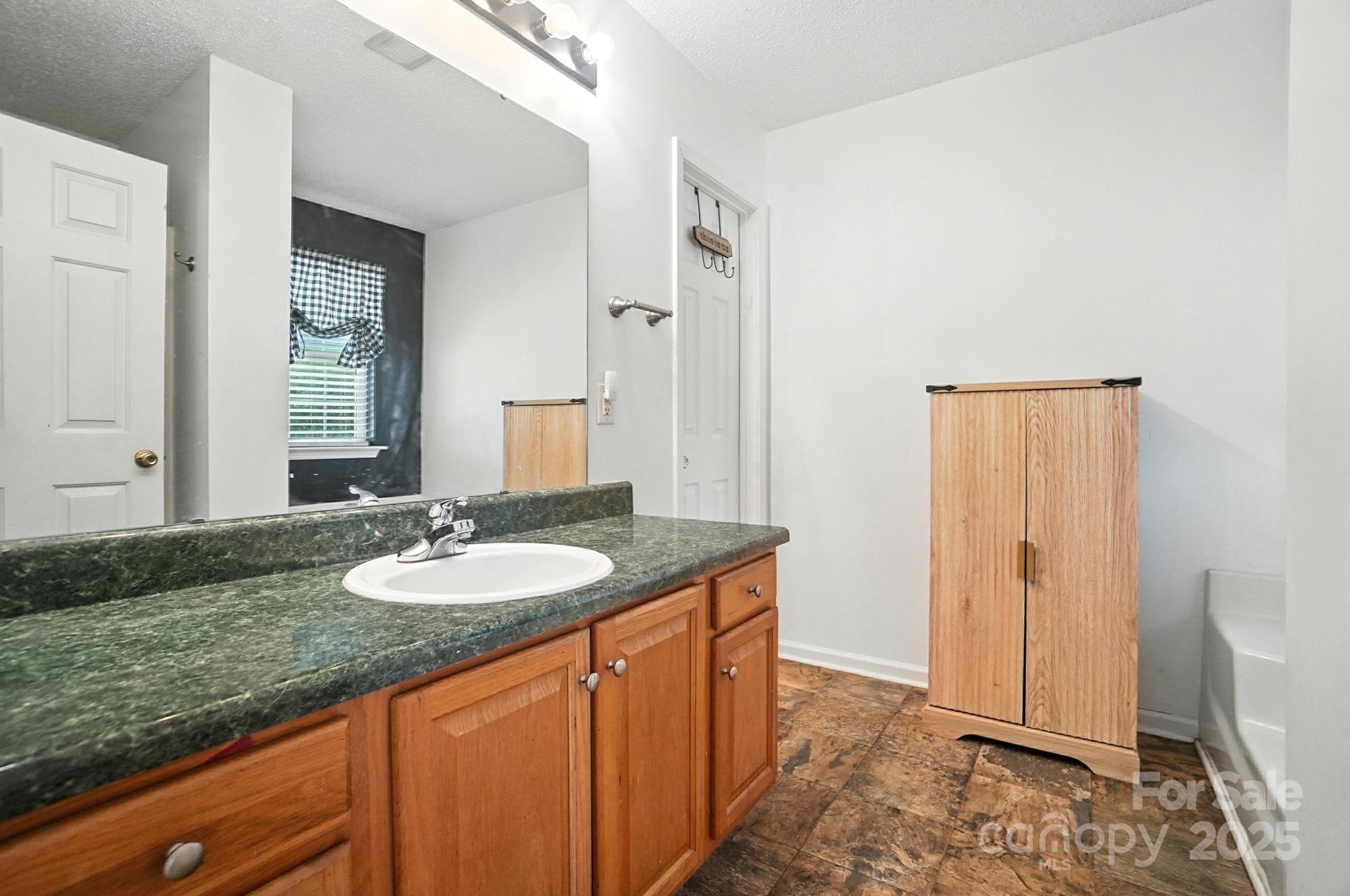 1116 State Rd S-29-770 Kershaw, SC 29067 - Photo 24 of 48 a bathroom with a granite countertop sink and a mirror