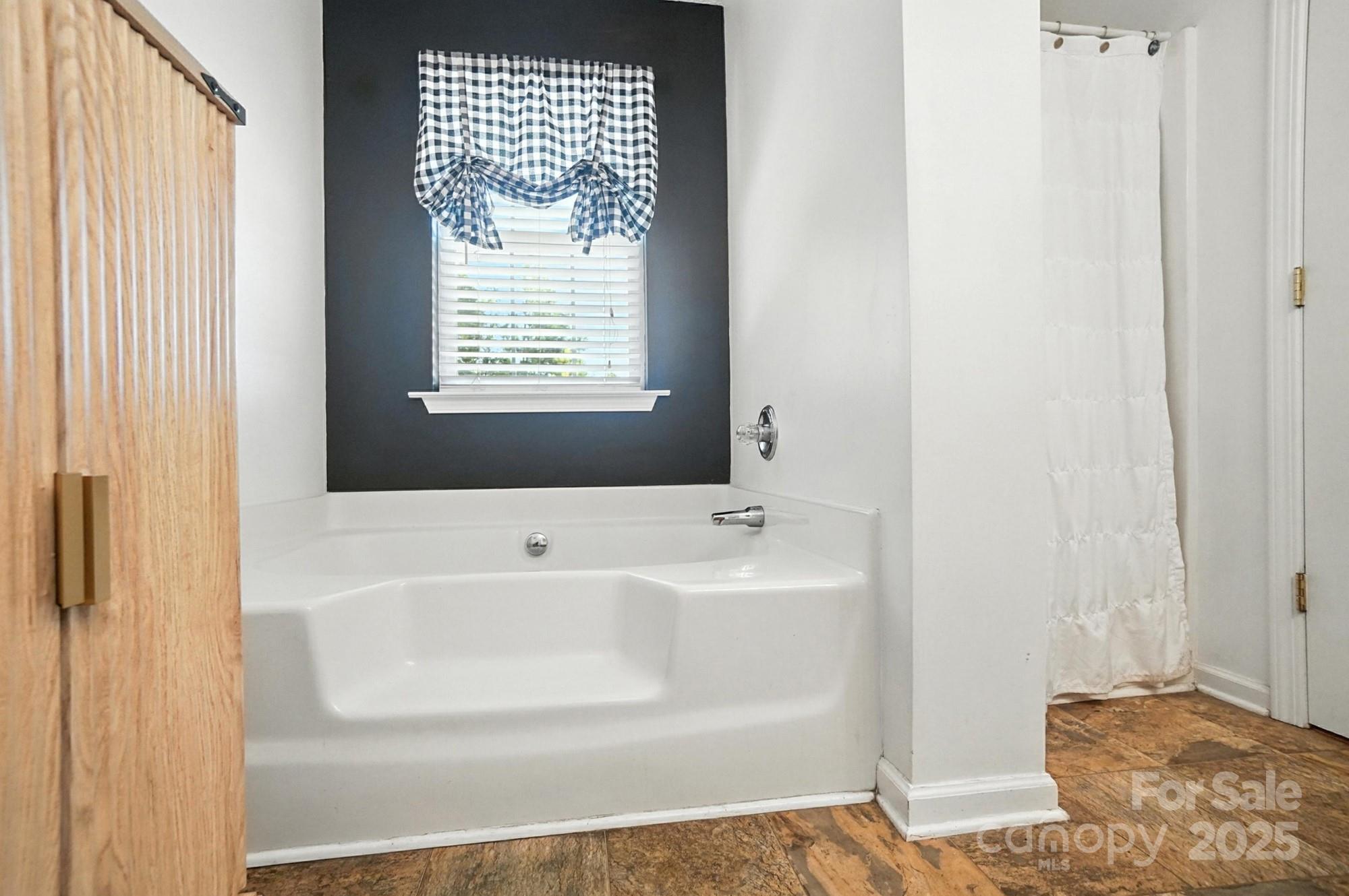 1116 State Rd S-29-770 Kershaw, SC 29067 - Photo 25 of 48 a bathroom with a bathtub and next to a window