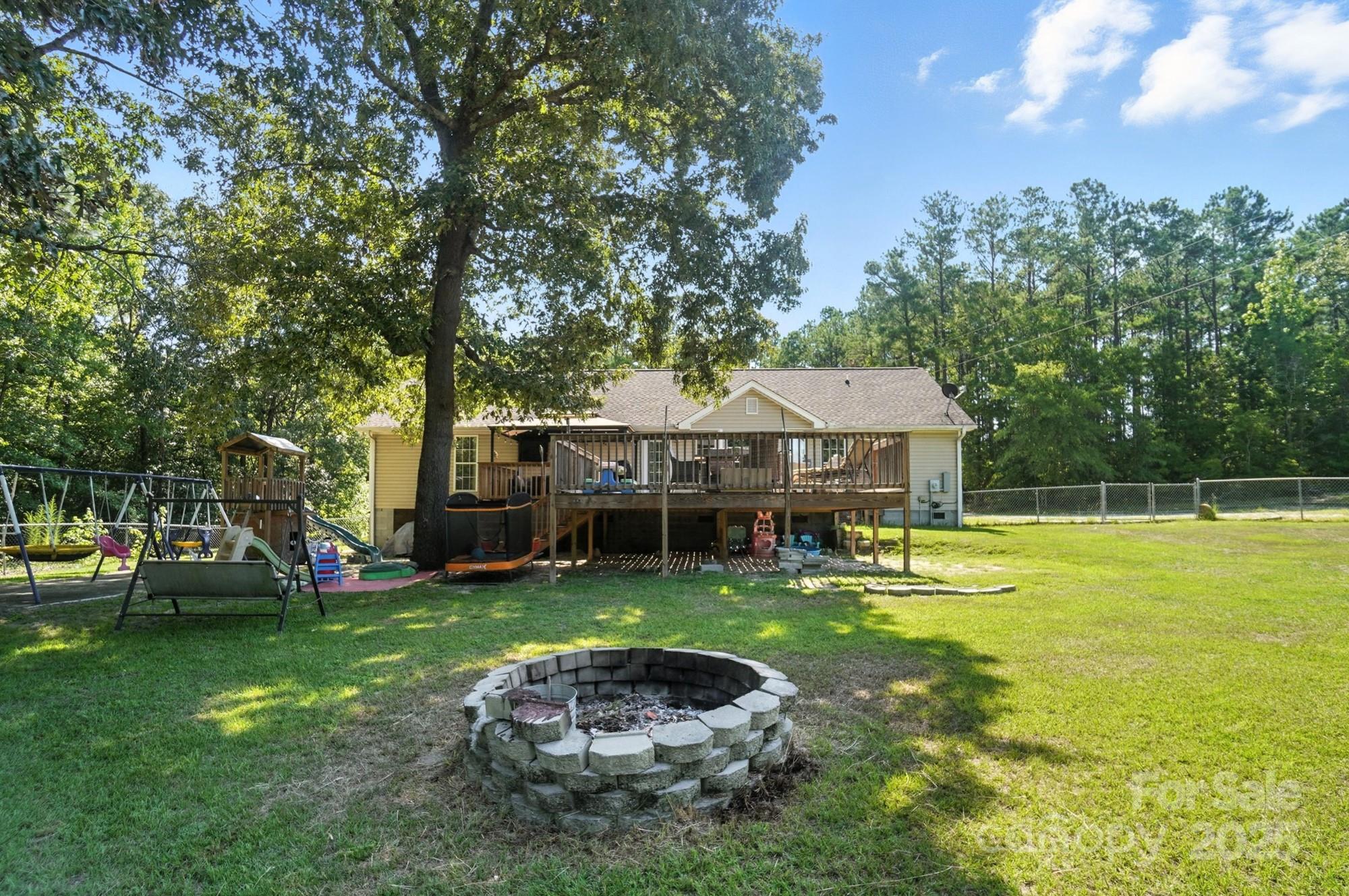 1116 State Rd S-29-770 Kershaw, SC 29067 - Photo 47 of 48 a house view with swimming pool and trees in the background