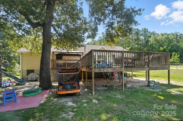 a view of a deck with a table chairs and a slide
